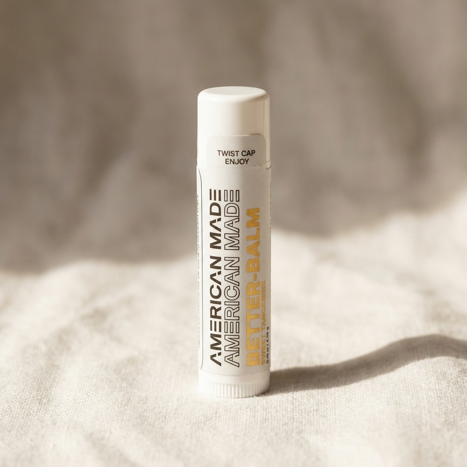 Lip balm with 'American Made' text on a textured beige background