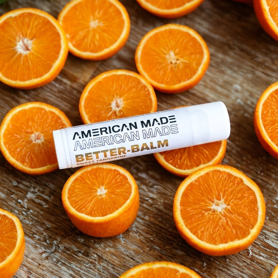 American Made Better Balm surrounded by sliced oranges on a wooden surface